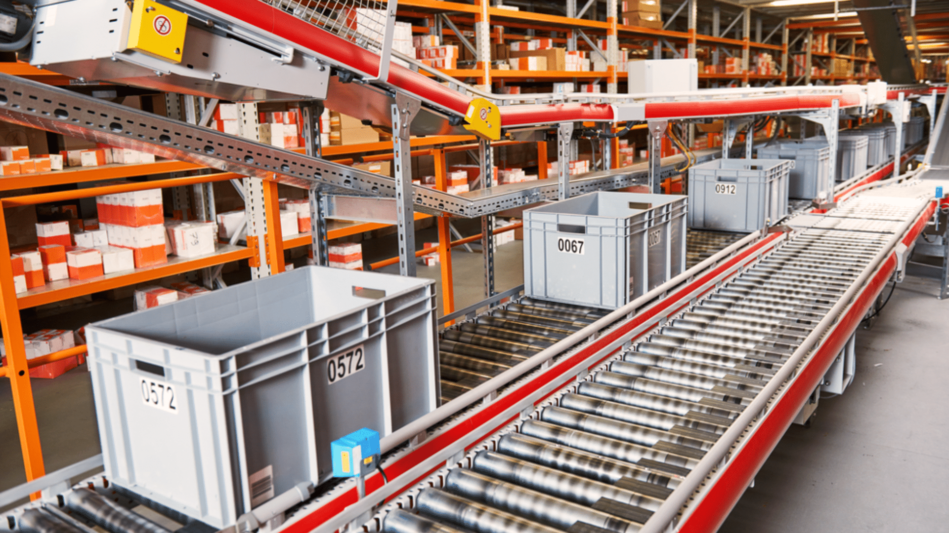 a conveyor system in a warehouse moving bins for sorting or transporting inventory efficiently