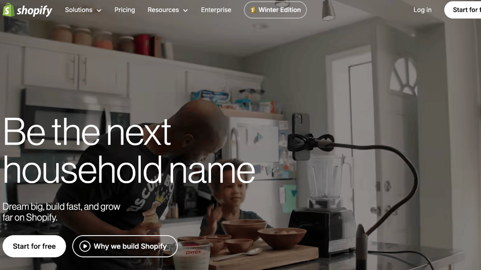 shopify homepage with entrepreneur and child in kitchen promoting ecommerce platform