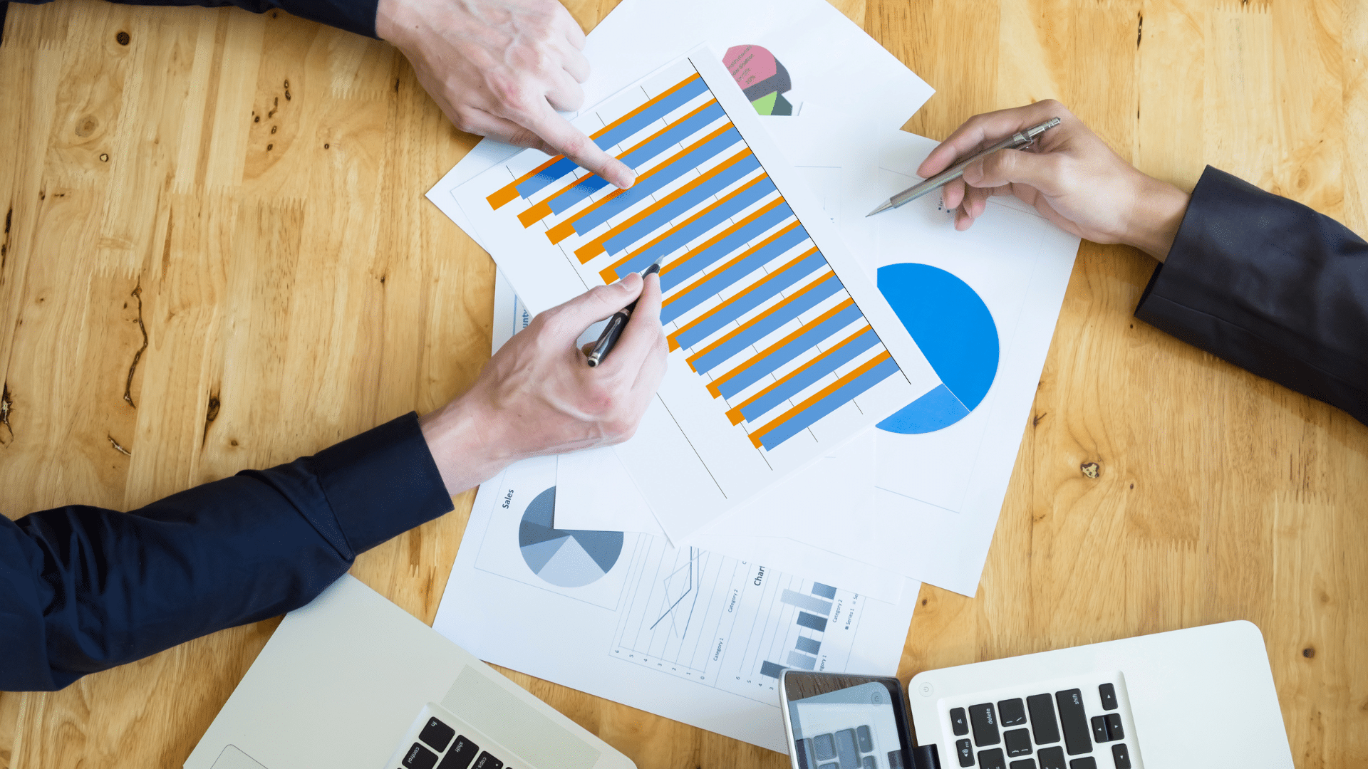 two people discussing with charts and graphs about risk management framework