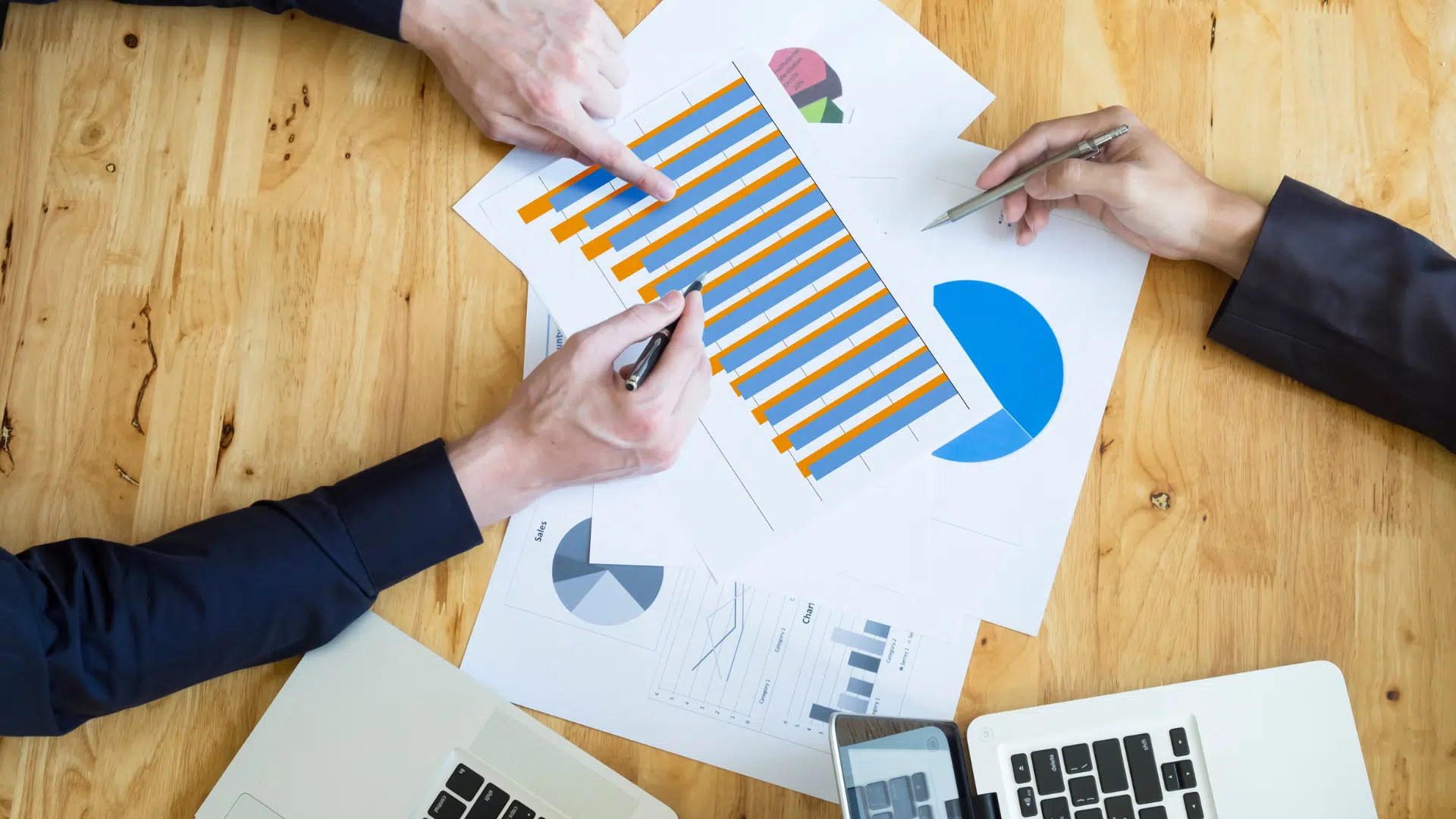 two people discussing with charts and graphs about risk management framework