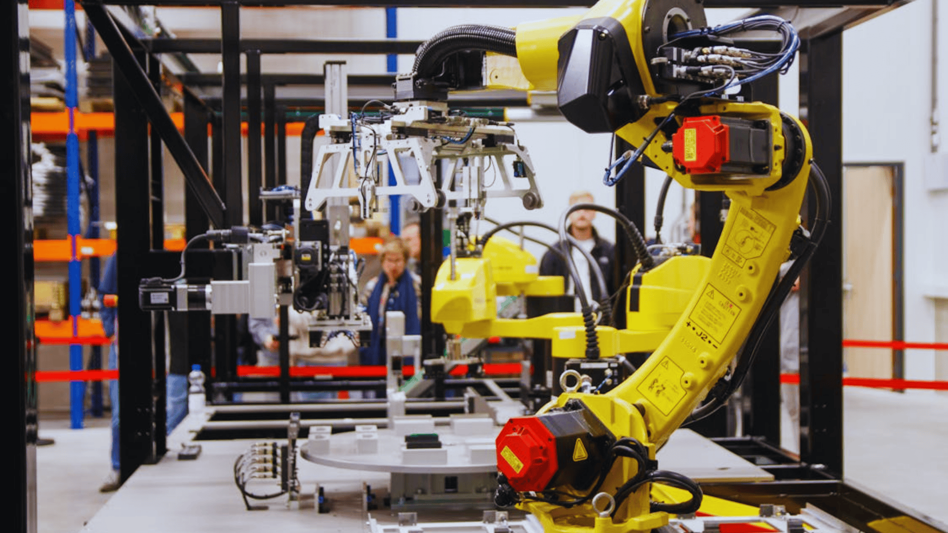 yellow industrial robotic arm operating in modern factory setting