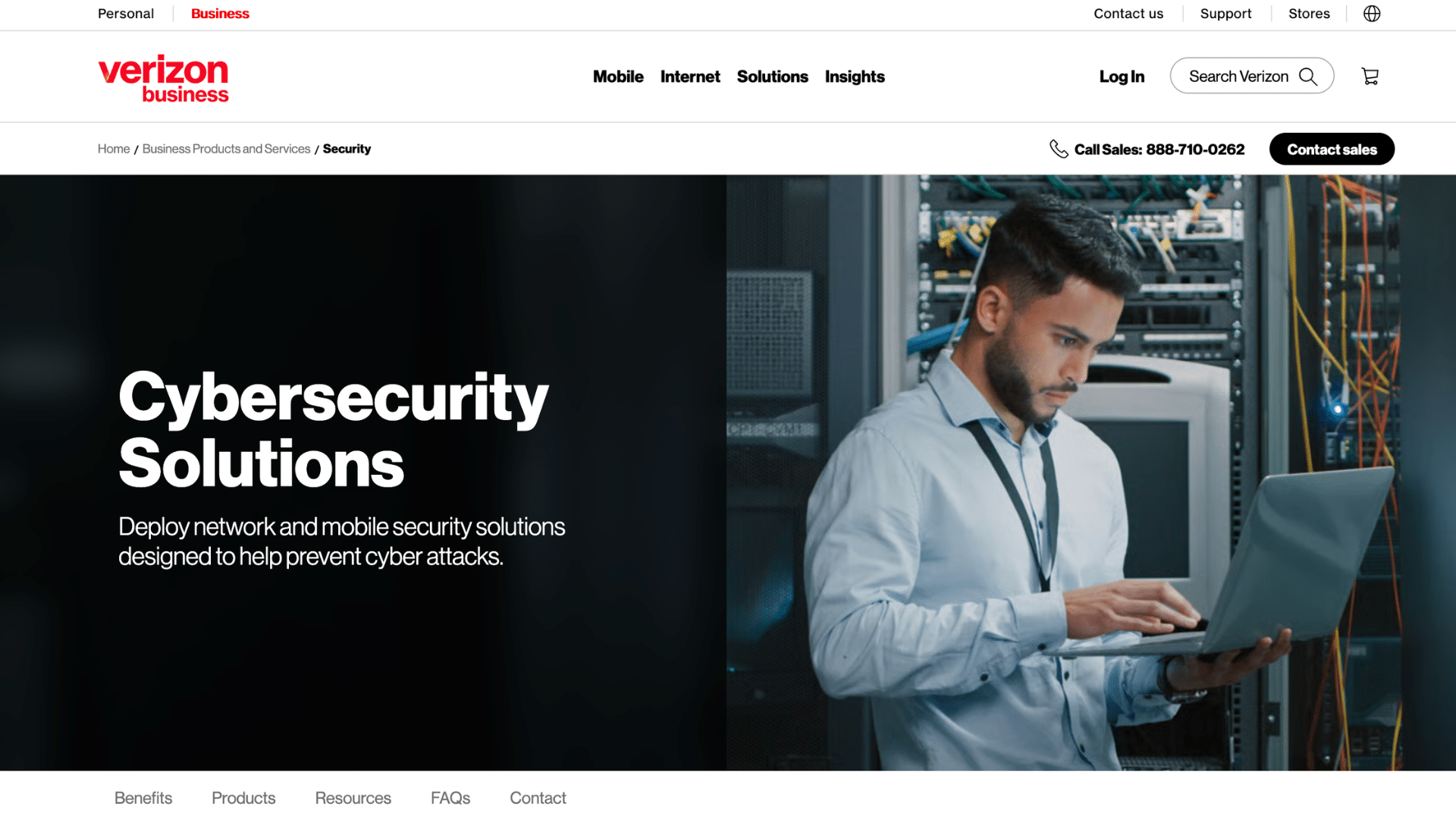 a man working on a laptop inside a server room while managing cybersecurity and network protection systems