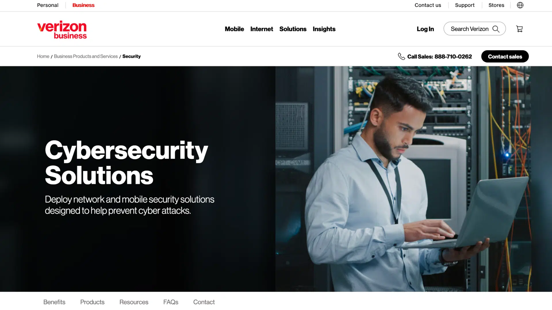 a man working on a laptop inside a server room while managing cybersecurity and network protection systems