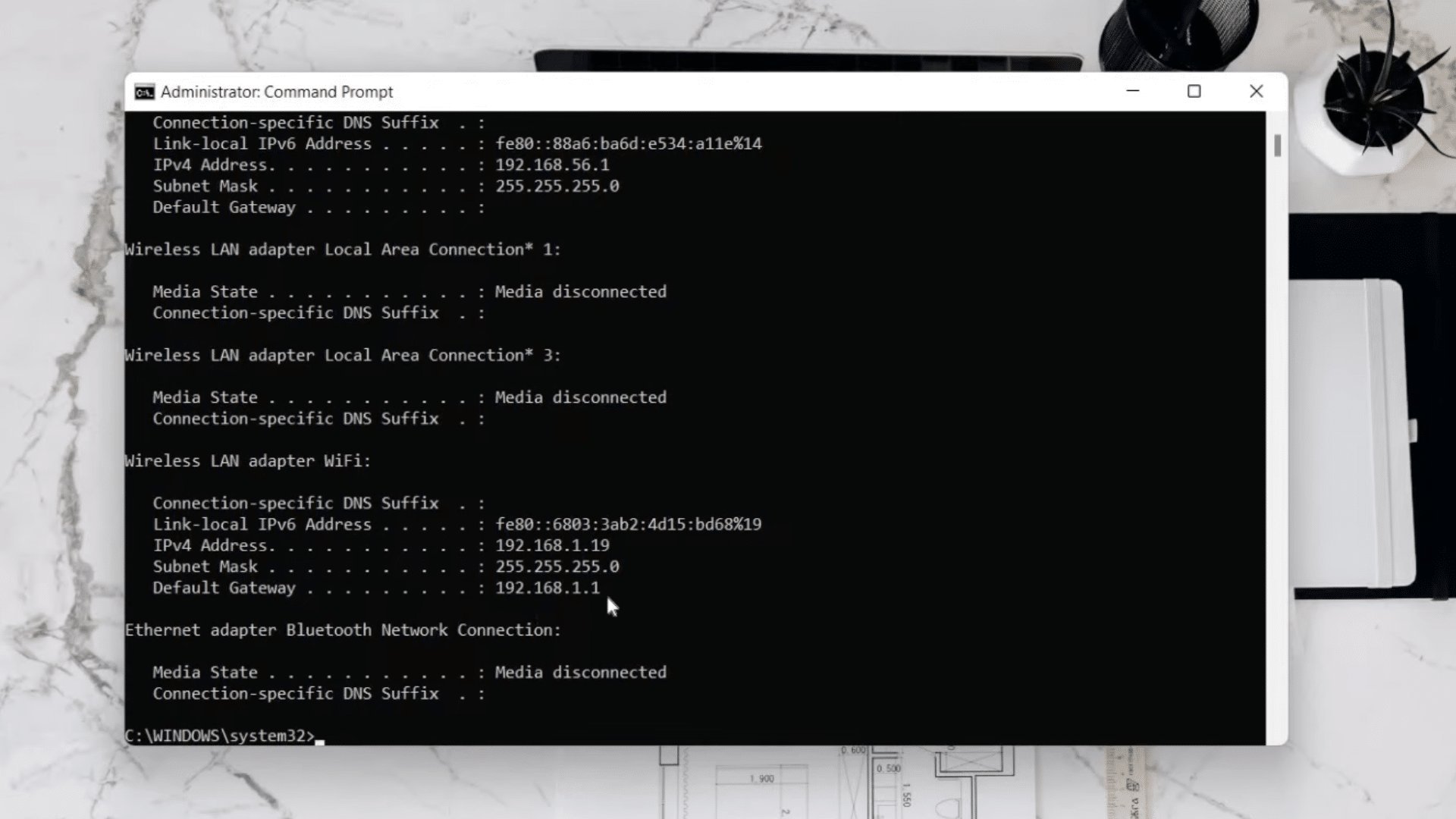 administrator command prompt window displaying ipconfig network details with ipv4 address and wifi adapter information on desktop screen