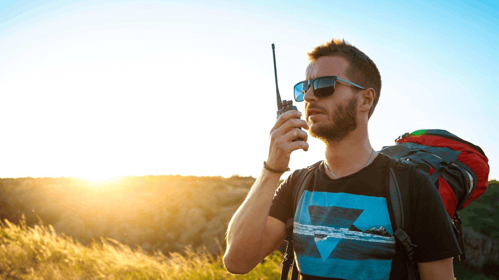 person using a satellite phone outdoors to communicate during an emergency situation (1)