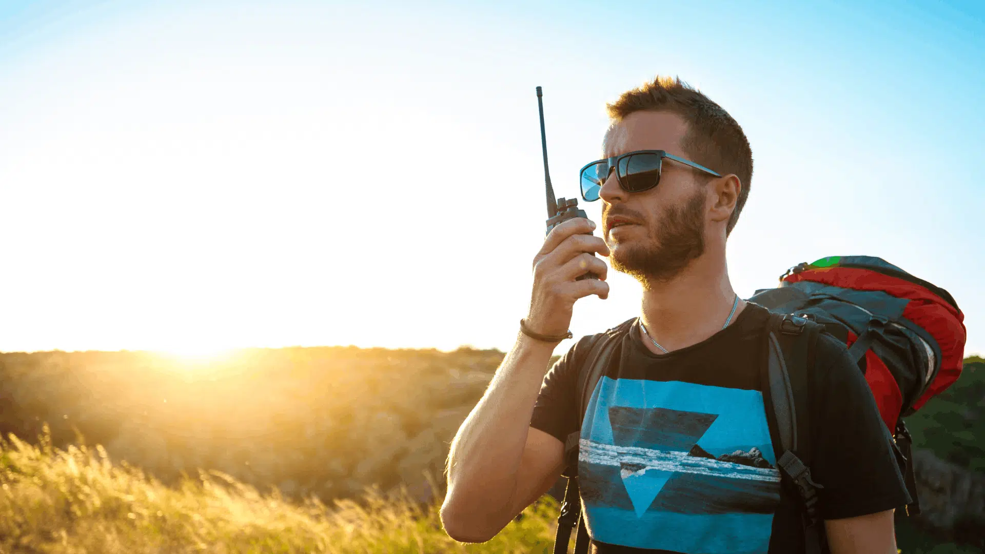person using a satellite phone outdoors to communicate during an emergency situation (1)
