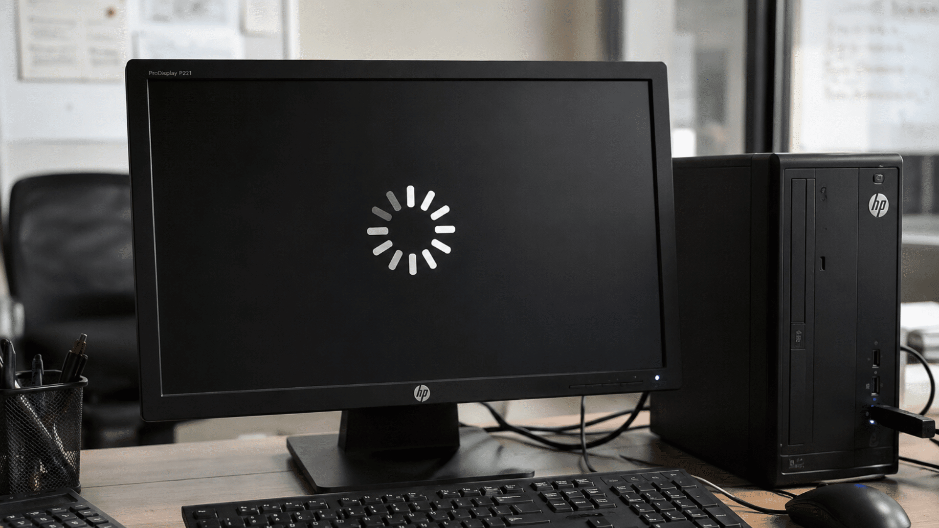 desktop computer showing a loading screen on a monitor indicating slow system performance in an office setup