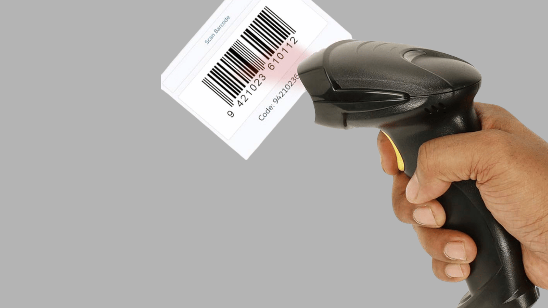 hand holding a barcode scanner aimed at a printed barcode label with the scanning device positioned for data capture