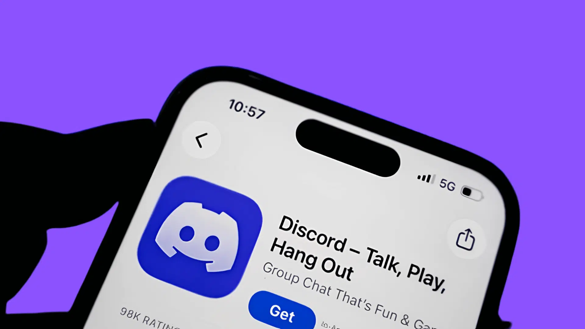 close up of a smartphone displaying the discord app store page with the app logo get button and purple background