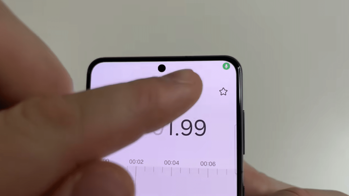 finger tapping the star icon on a smartphone stopwatch screen with timer counting seconds near top display