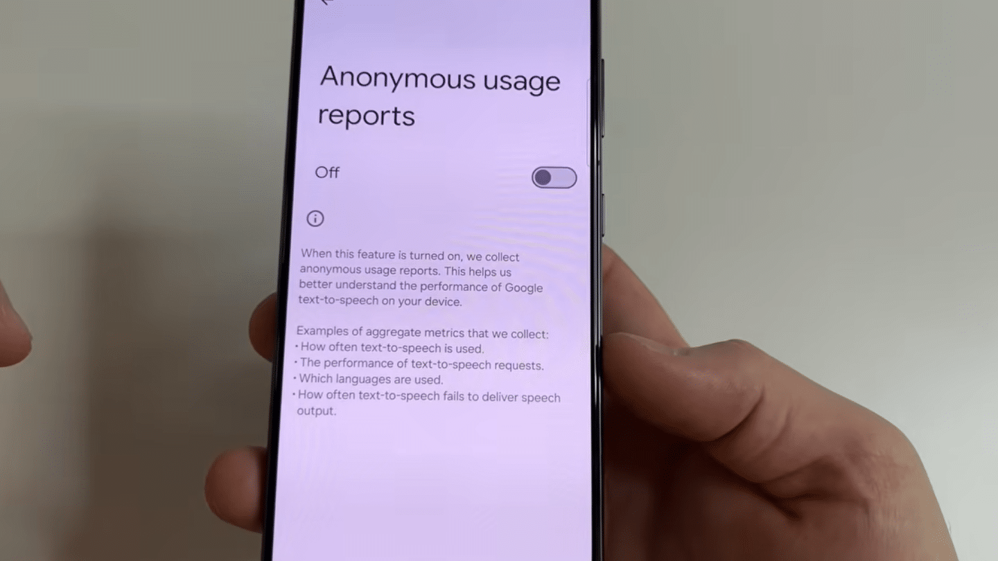 hand holding smartphone showing anonymous usage reports setting screen with toggle switch turned off