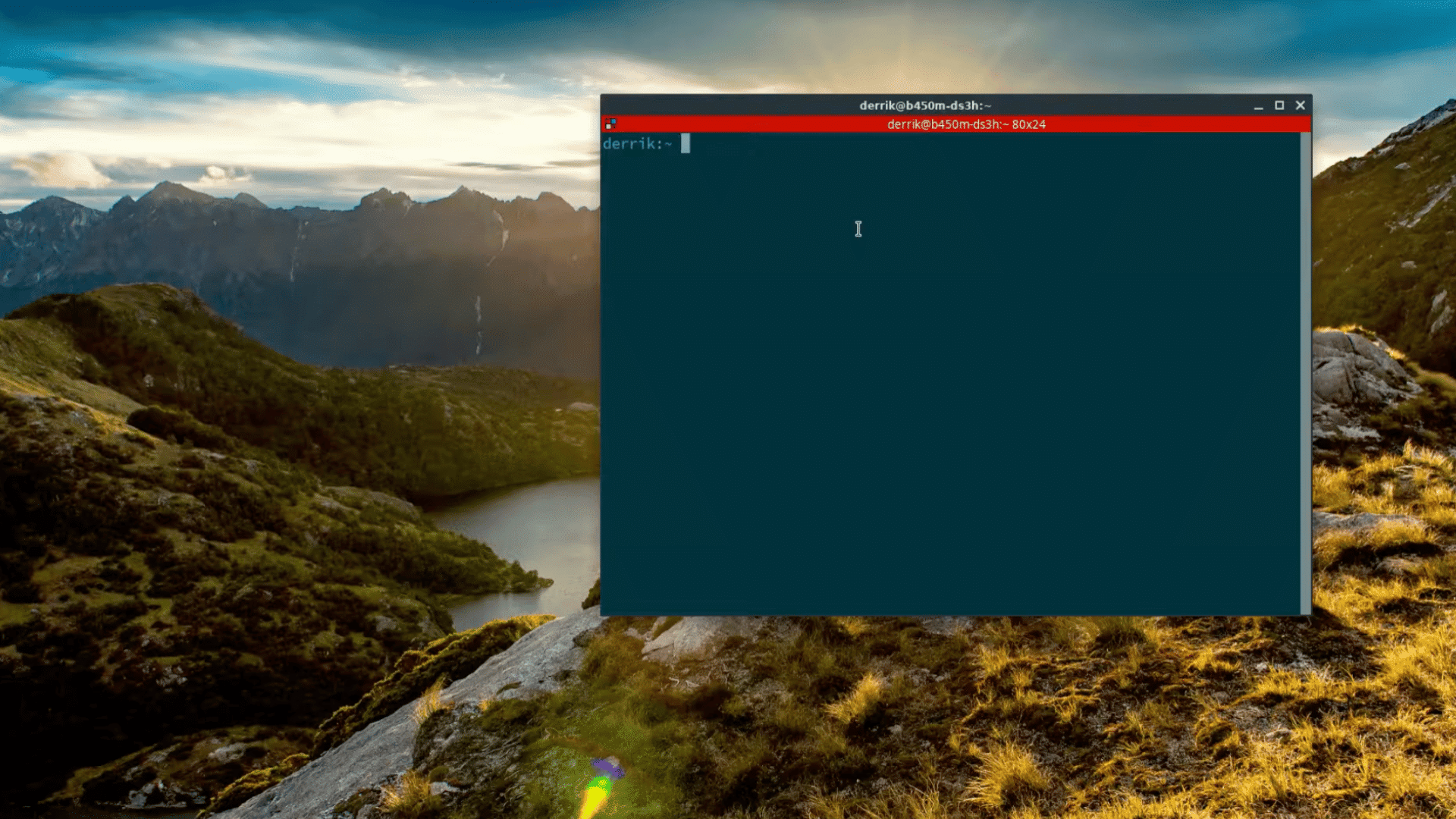 linux desktop showing an open terminal window over a mountain landscape wallpaper with sunlight across hills and a lake