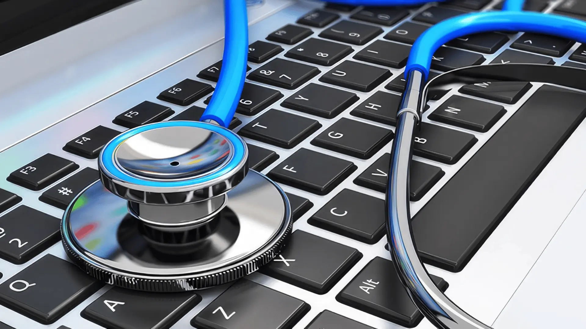Blue stethoscope resting across a laptop keyboard to represent a computer health check.