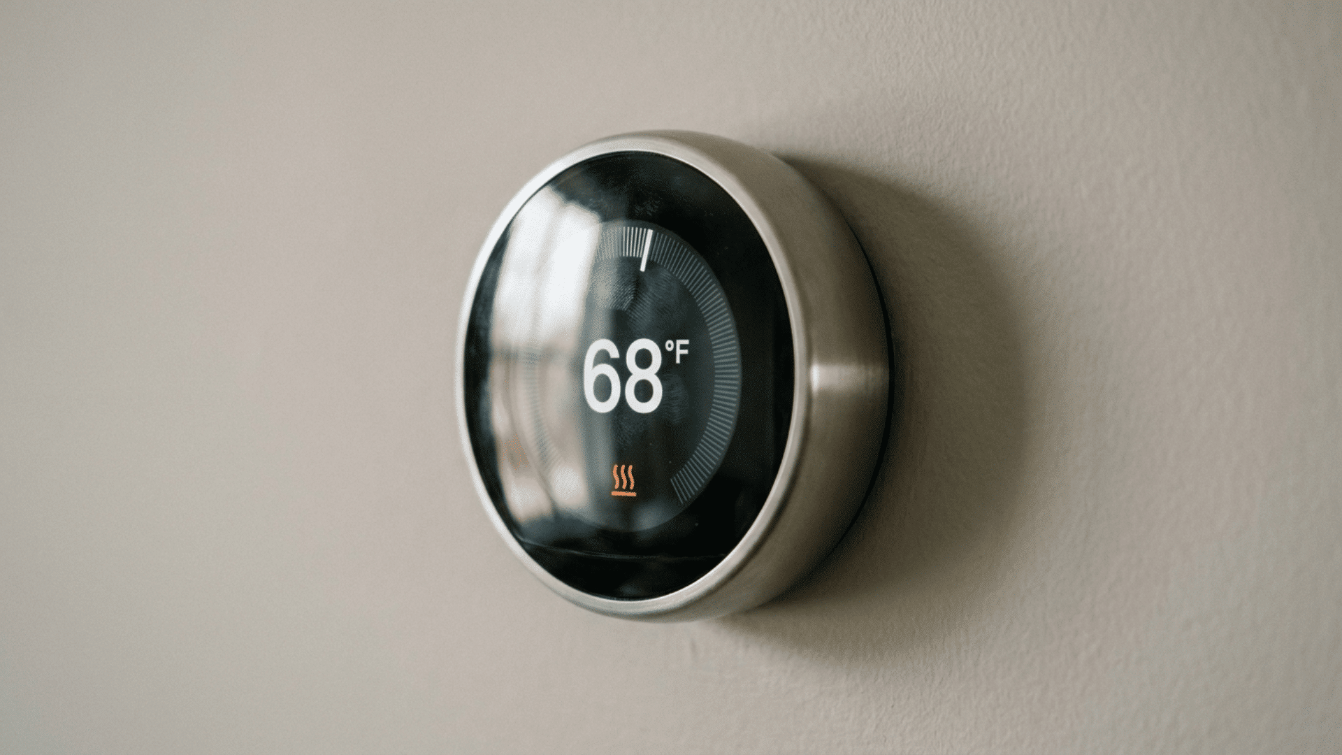 a round smart thermostat mounted on a plain wall