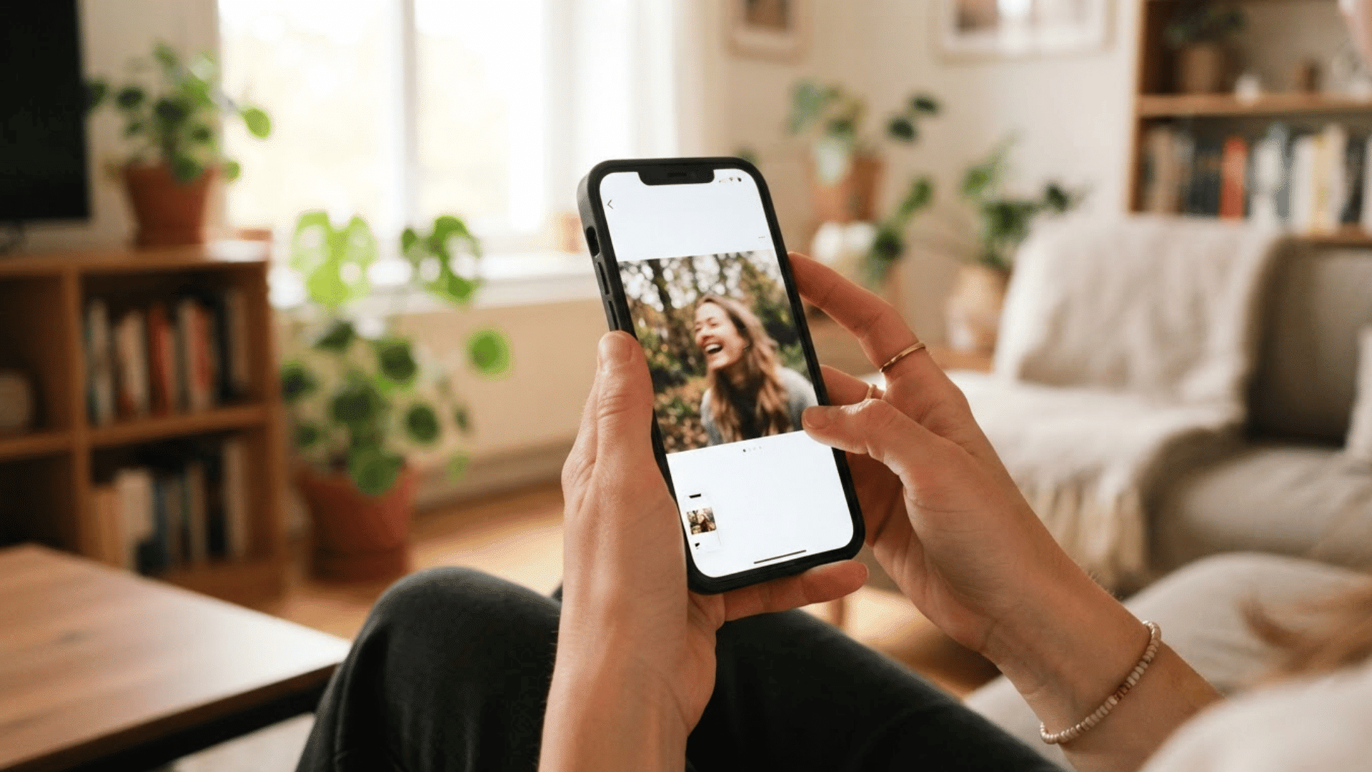 phone showing an instagram story as a hand presses screenshot buttons nearby inside a home