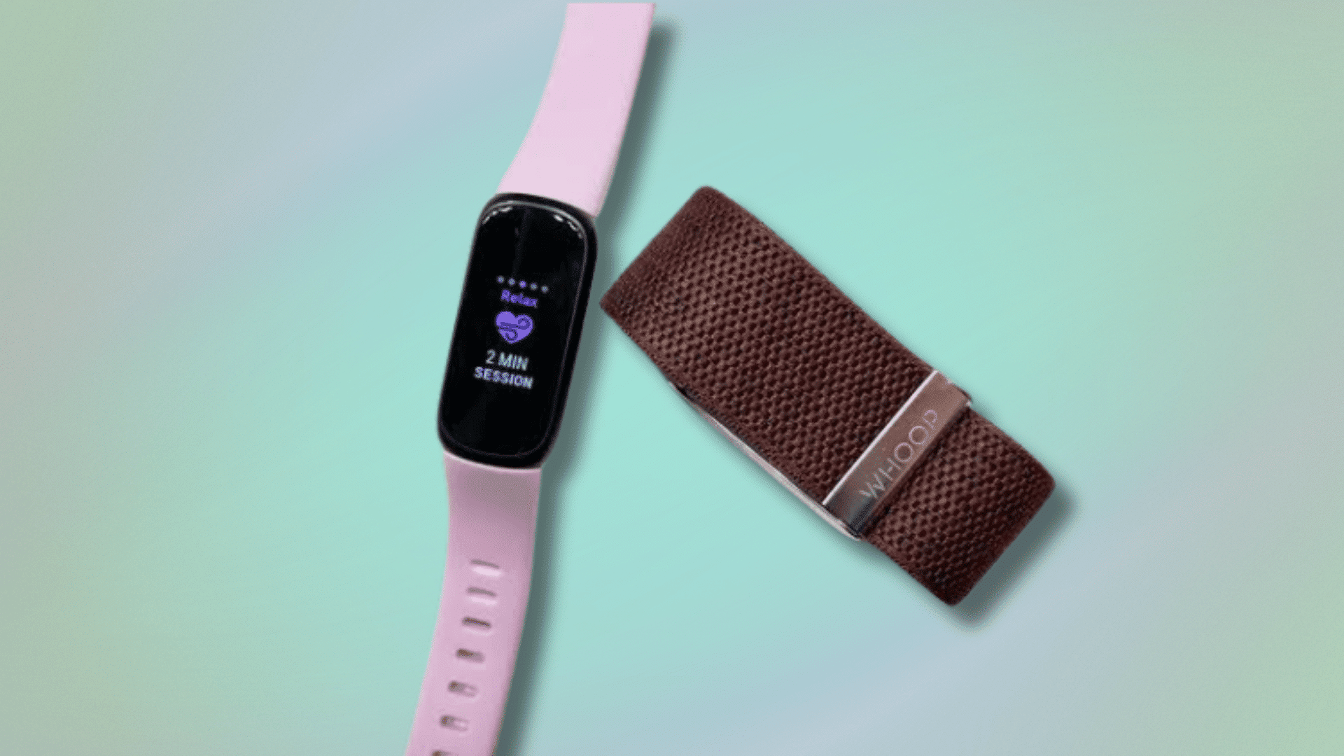 fitbit tracker with pink band and whoop recovery band placed on pastel background