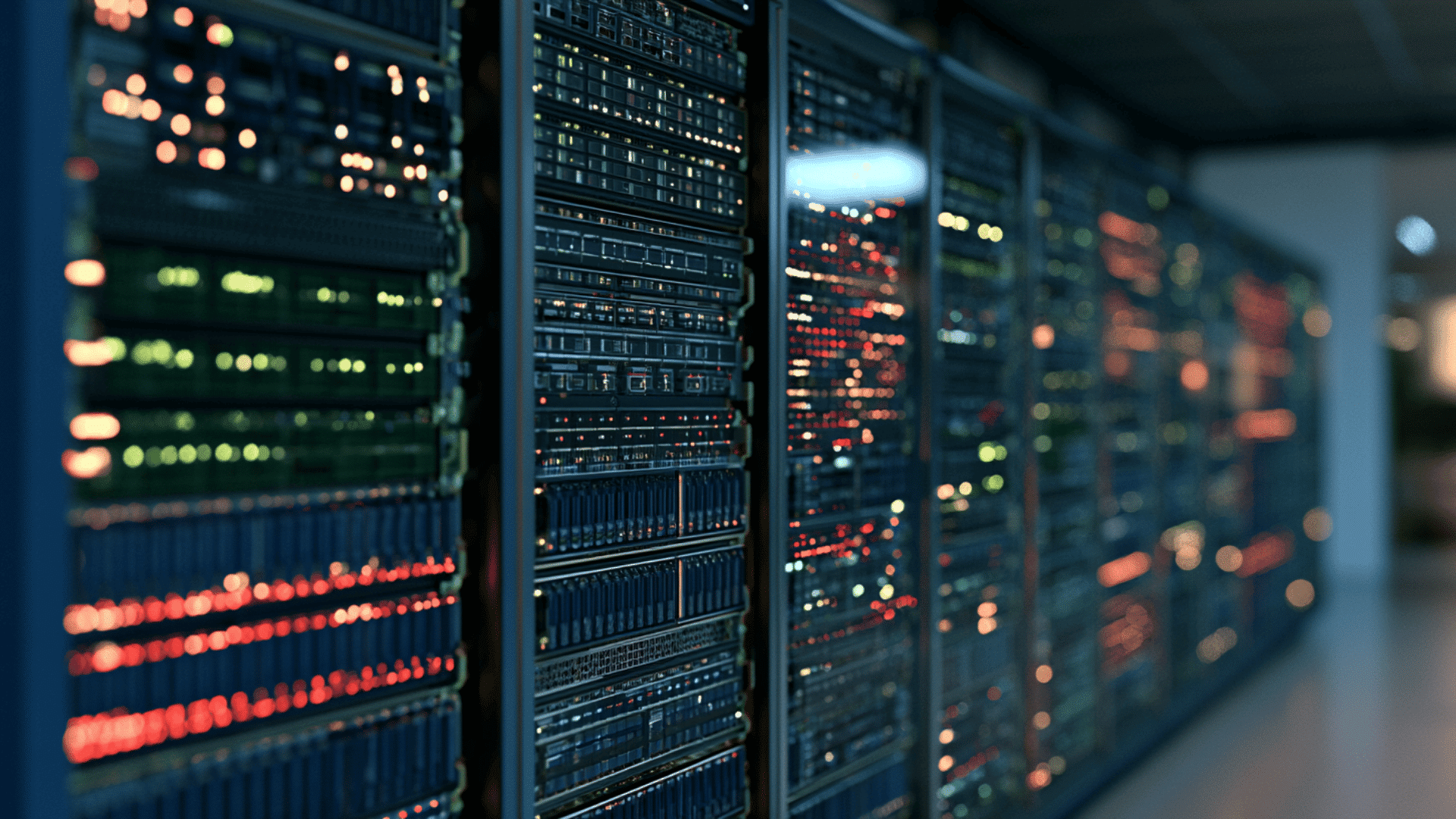 rows of computer server racks with glowing status lights inside a modern data center facility