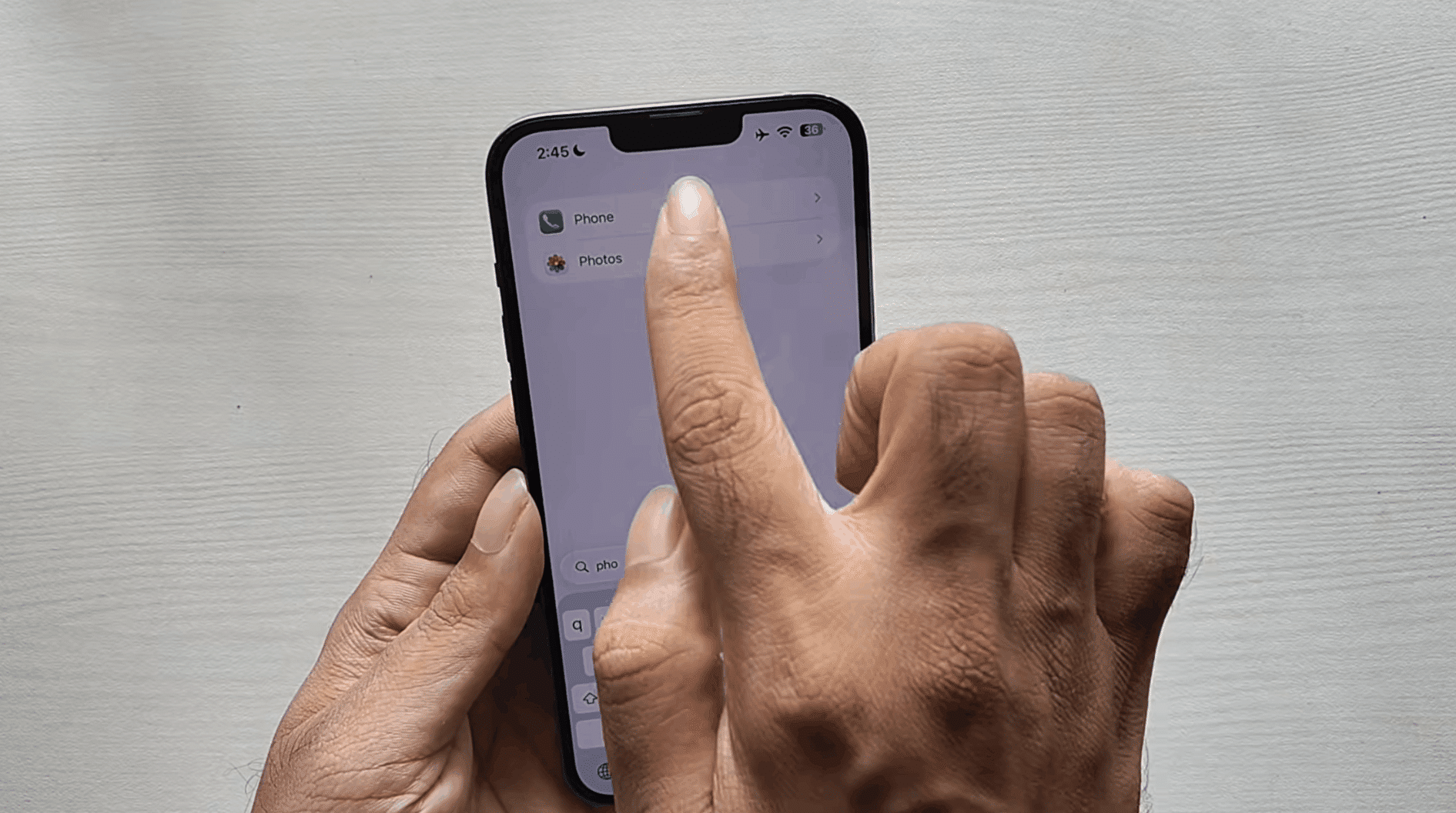 hand holding smartphone tapping screen