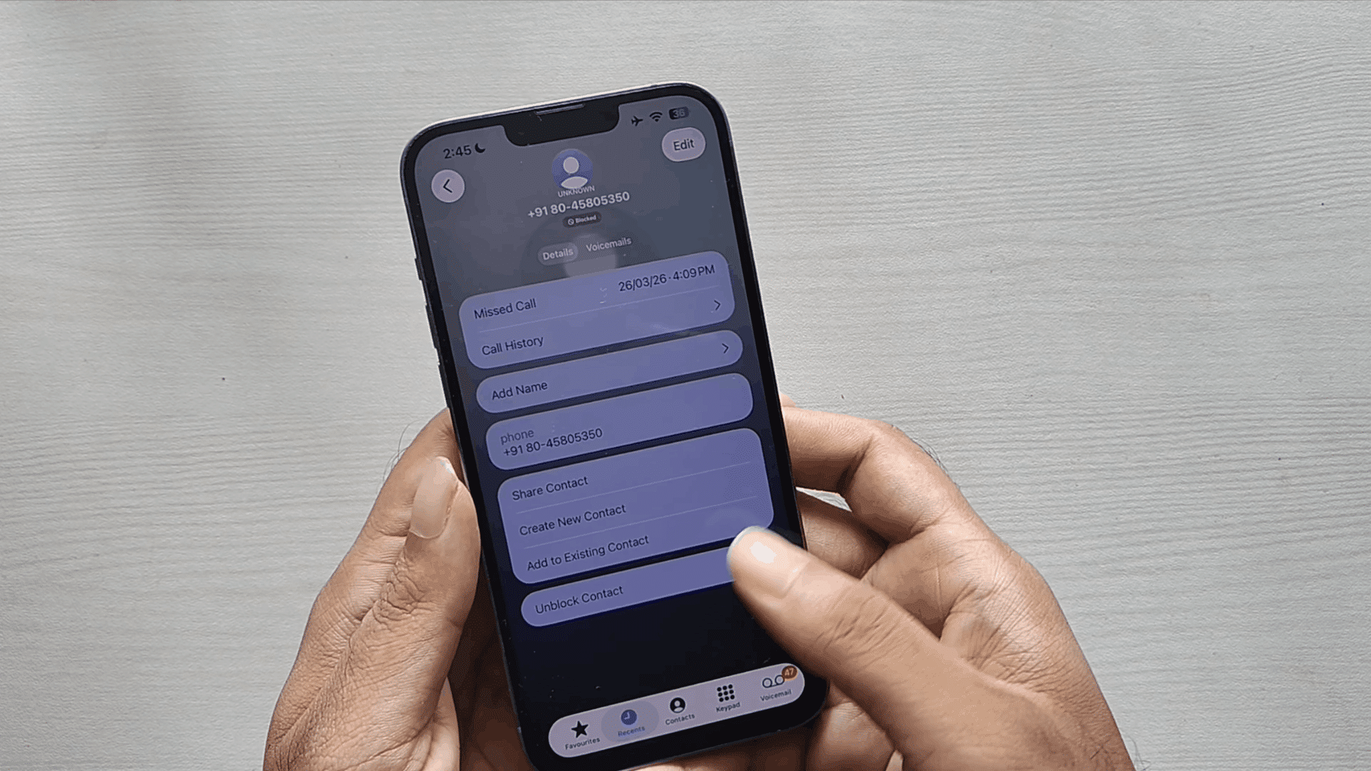 iphone contact details screen showing blocked number with unblock contact option and call history on display