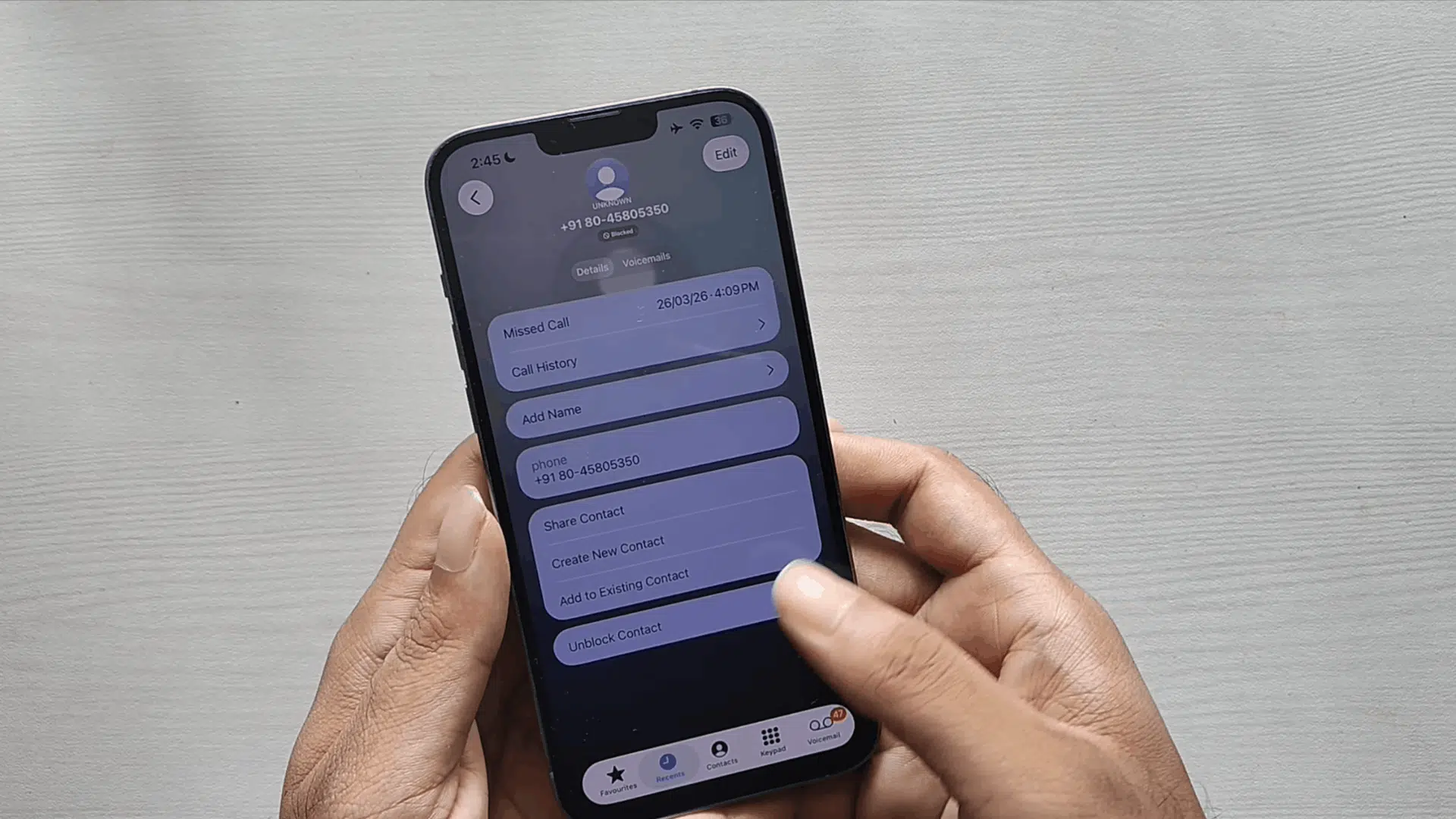 iphone contact details screen showing blocked number with unblock contact option and call history on display