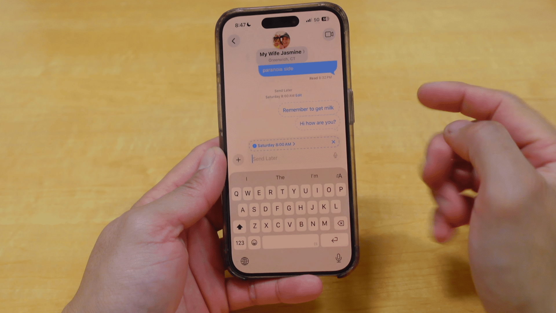 person viewing scheduled messages in an imessage conversation with the keyboard open after setting send later reminders