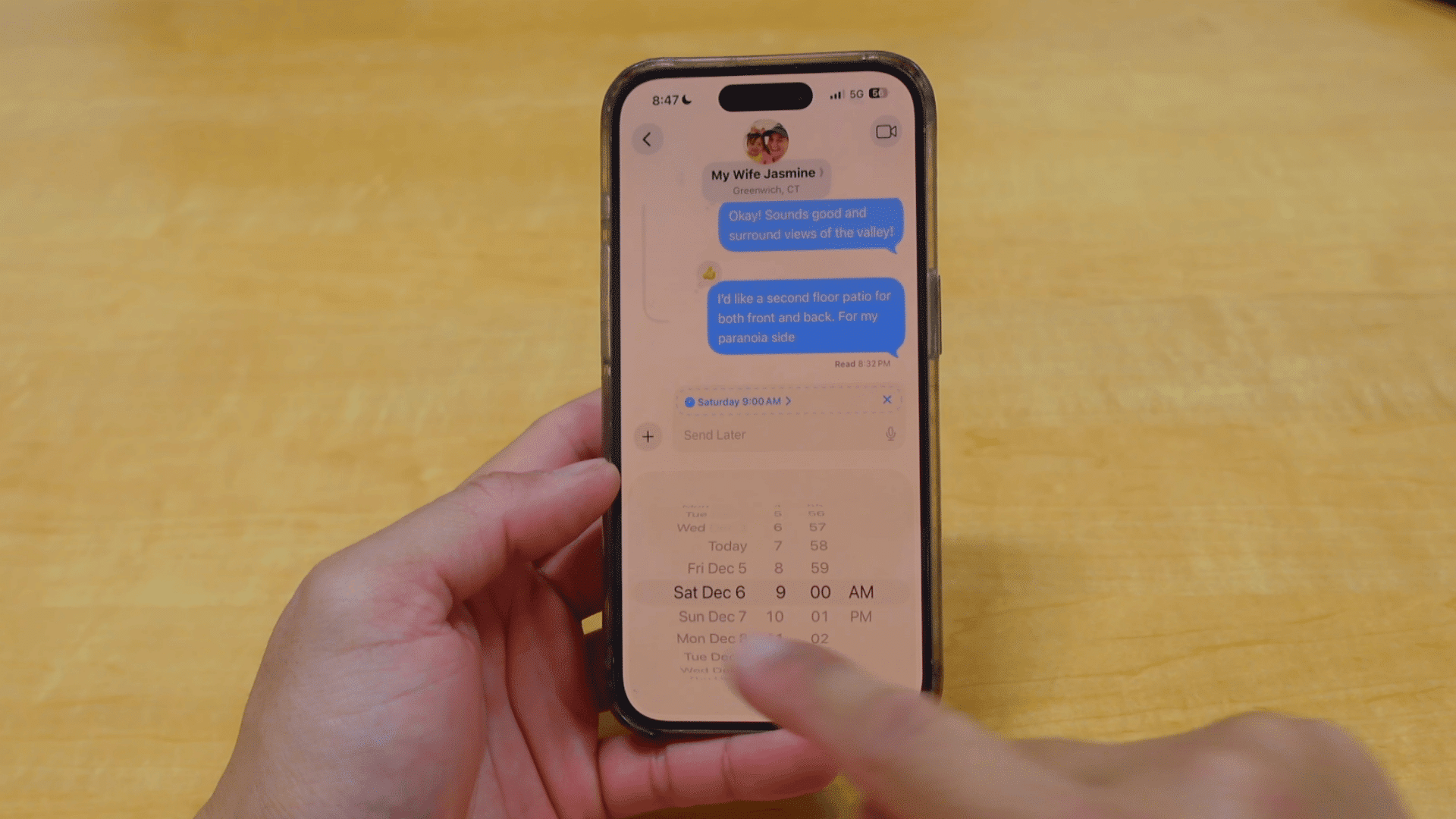 person choosing a scheduled delivery time for an imessage using the send later feature on an iphone